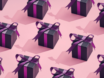 Photo of pink gifts in a row on pink background